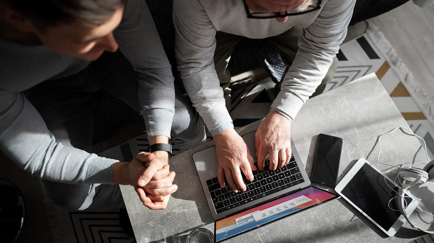 people looking at a computer discussing web design trends